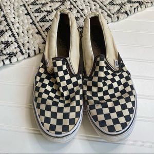 Extremely worn checkered slip on vans
